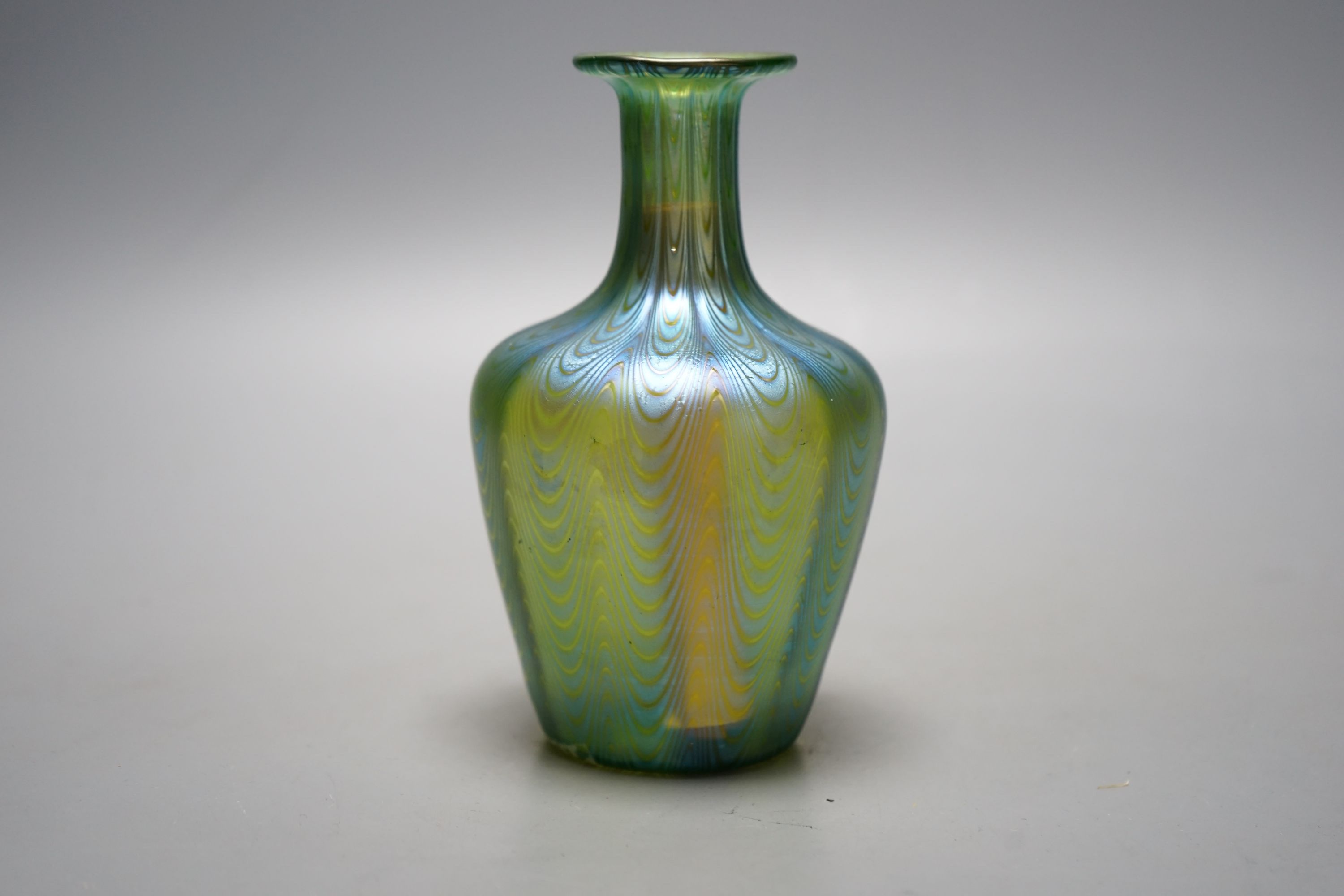 A Loetz style iridescent glass vase, flared narrow neck and bulbous body waved decoration, 14 cms high.